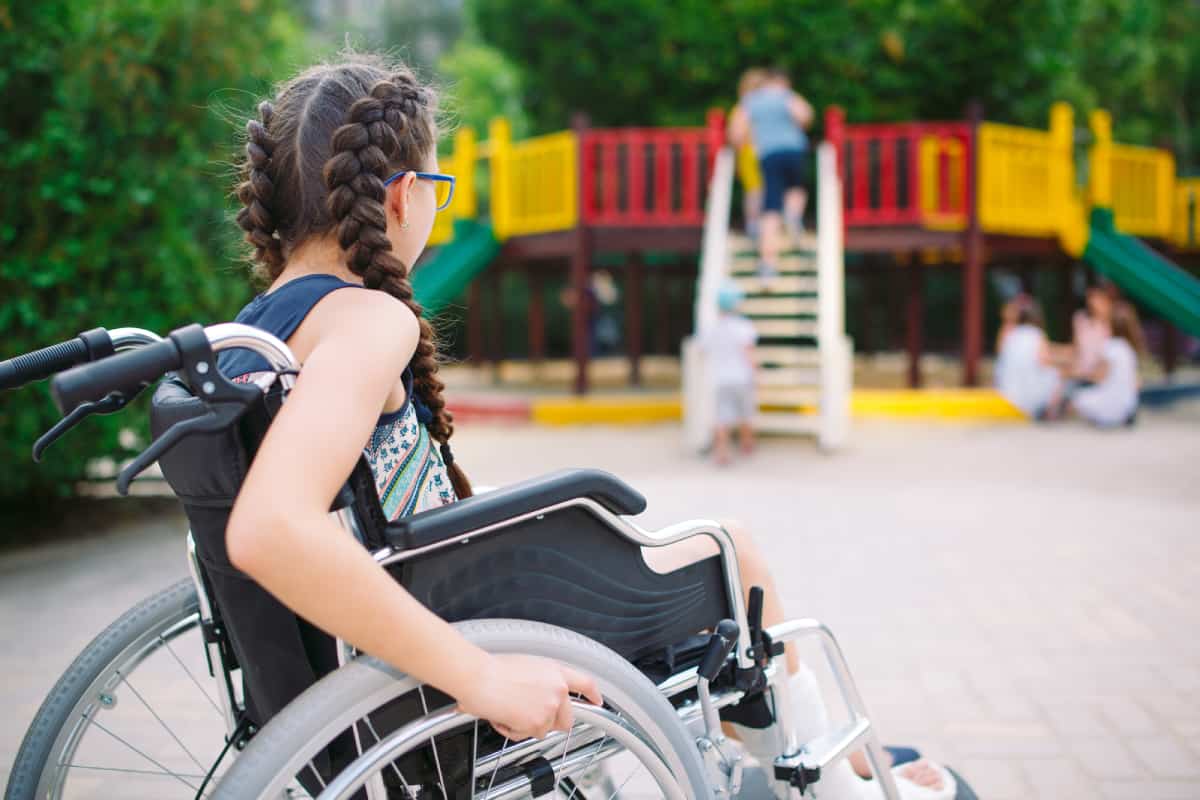 Children with and without disabilities playing together on an inclusive playground — every child deserves to belong
